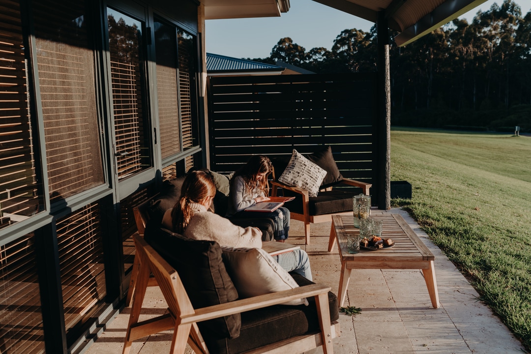 Enjoying the private terrace on school holidays at Tanah Marah lakeside accommodation Margaret River